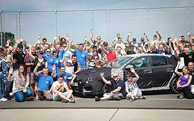 Gruppenfoto beim Hyundai N Motorsport-Treffen mit Community und Fahrzeug im Hintergrund